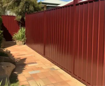Newly installed red Colorbond fence in Jimboomba